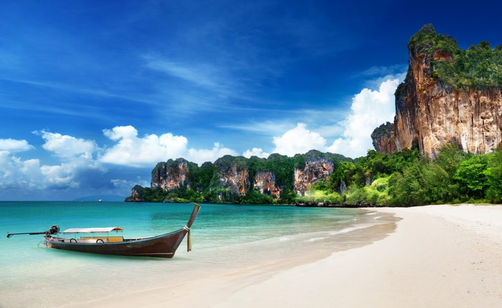 A long-tailed boat parks at Railay Beach, Krabi